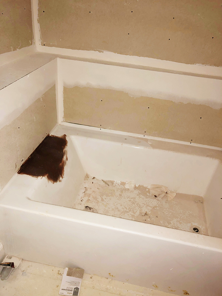 Before and after pic of giant hole in bathtub repair