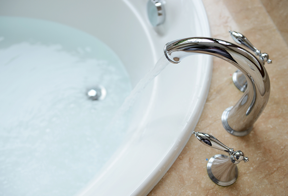 luxury bath tub Bathtub filling with water from a running spigot